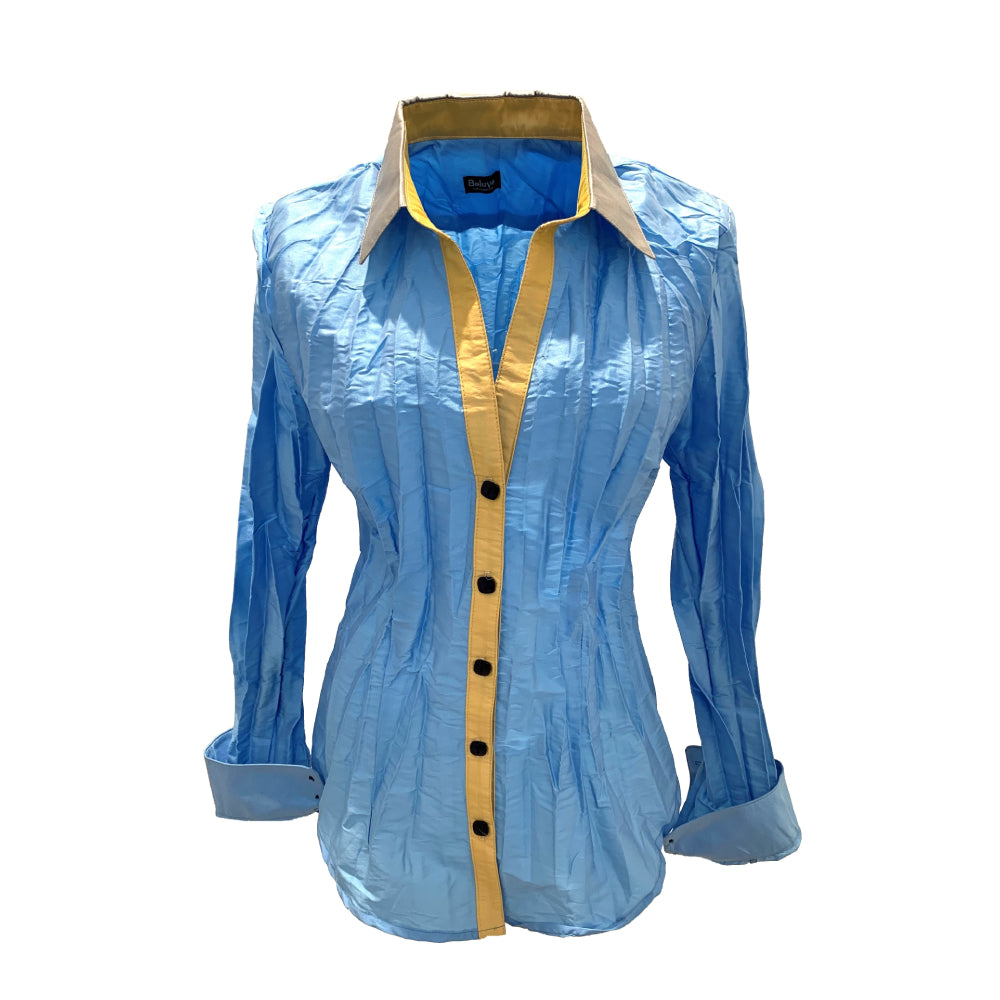 The classic cut blouse is Sky-blue with honey colored collar and front placket, the buttons are dark blue. Sky blue can be described as a soft light blue with a hint of yellow inspired by the daytime sky. Honey is a warm sunny yellow complementing the blue of the shirt. 